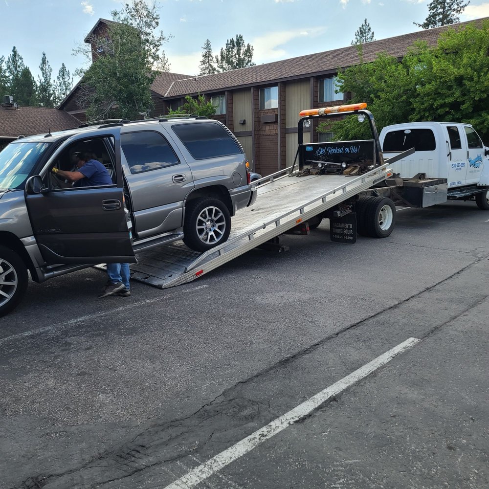 Image of an SUV getting pulled onto a tow truck